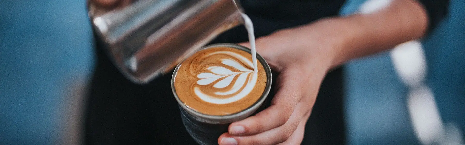 Latte being poured into cup